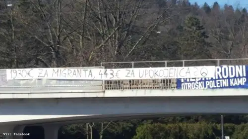 “1930€ za migranta, 443€ za upokojenca” transparent krasi nadvoz v Ljubljani